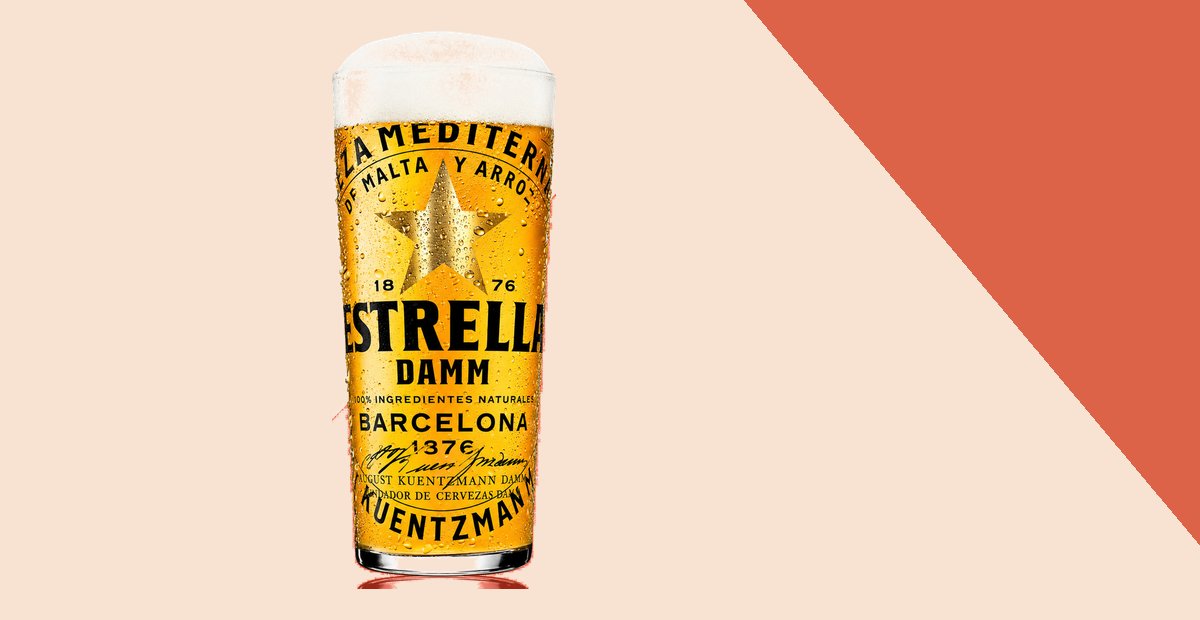 A tall glass of Estrella Damm draft beer from Barcelona, poured with a full head